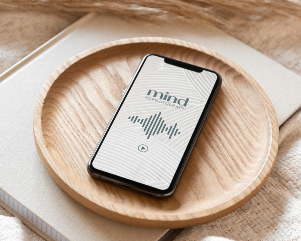 iPhone with a screen that has the Mind Hypnotherapy logo and and audio file of a sessions playing